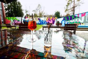 a glass table with two wine glasses on top of it at Das Edlinger in Salzburg