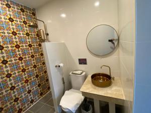 a bathroom with a toilet and a mirror at Lemon Guesthouse in Chiang Mai +49 photos