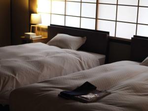Lova arba lovos apgyvendinimo įstaigoje NIPPONIA HOTEL 伊賀上野 城下町