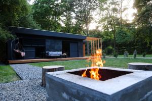 a fire pit in the backyard of a house at Forestlux Vendégház in Zebegény