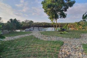 a river with a bridge in the middle of a yard at Fairway Grove at Iba, Zambales in Dirita