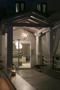 a room with a table with a light on it at Hotel Rezi in Parga
