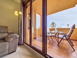 a living room with a glass door leading to a patio at La Serena Apartment - 3410 in Los Alcázares
