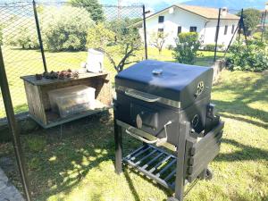 a grill sitting on the grass in a yard at Villa Rosi in Lierna