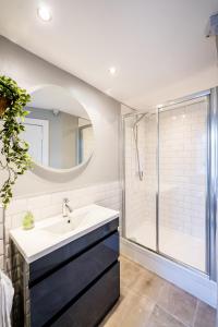 a bathroom with a sink and a shower at Garden Flat West Kincaple House in St. Andrews