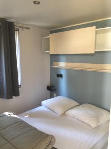 a bedroom with two beds and a window at Camping Milella in Propriano