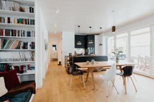 a dining room and living room with a table and chairs at Aloha Pruchten in Pruchten