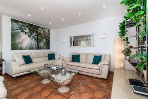 a living room with a couch and a table at Villa Isabel Sol in Adeje
