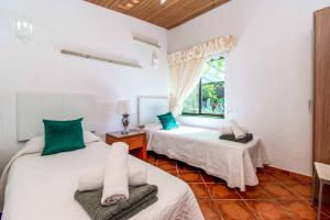 two beds in a room with a window at Villa Isabel Sol in Adeje +58 photos