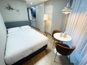 Habitación pequeña con cama y mesa en INN-The City MyeongDong, en Seúl