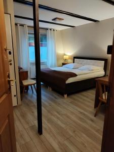 a bedroom with a large bed and a table at Hotel Zdrojewo in Nowe