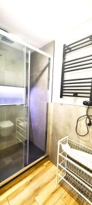 a bathroom with a shower with a glass door at Oshun Plaza Castilla in Madrid