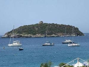 a group of boats in the water with an island at IL DIAMANTE SUL MARE in Diamante +18 photos