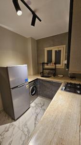 a kitchen with a refrigerator and a washer and dryer at My Villa in Sheikh Zayed