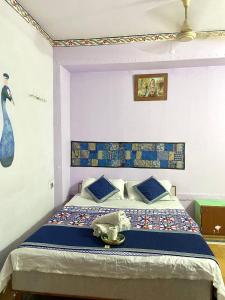 a bedroom with a bed with a stuffed animal on it at Little Prince Home Stay in Jaisalmer