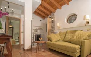 a living room with a couch and a table at Villa Schuler Taormina GARDEN SUITE IN SELF-CATERING in Taormina