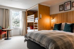 a bedroom with a bed and a bunk bed at The Park Hotel in Teddington