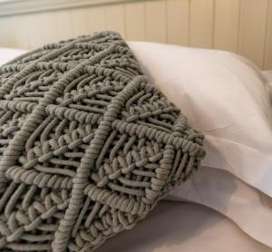 a gray blanket laying on top of a pillow at Church Cottage in Beadnell