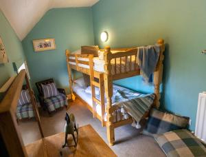 a room with two bunk beds in a room at Church Cottage in Beadnell