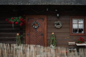 a house with a wooden door with wreaths on it at Dreveničky Holúbkovia in Terchová