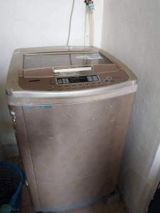 a fax machine sitting on top of a refrigerator at ARAH Homestay @ Kuhara Court Tawau in Tawau