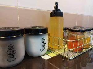 two coffee cups sitting on a counter next to a shelf at ARAH Homestay @ Kuhara Court Tawau in Tawau