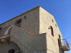 a building with a staircase on the side of it at SunSea in Calatabiano