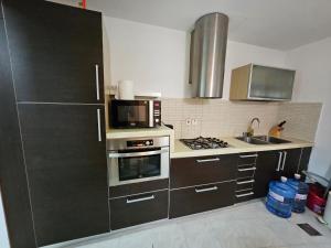 a kitchen with a microwave and a stove top oven at The Belvedere Marina Inn, Heart of Marina in Dubai