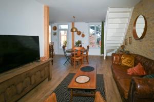 a living room with a couch and a table at Appartement - Le James in Carnac