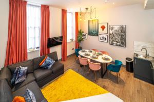 a living room with a couch and a table at Duke Street Townhouse in Liverpool