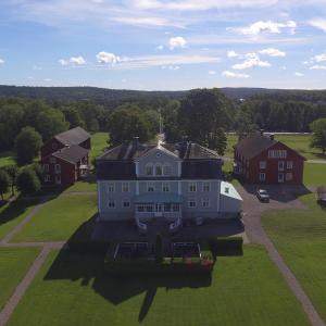 an aerial view of a large house on a green field at Svaneholm Hotel in Svanskog