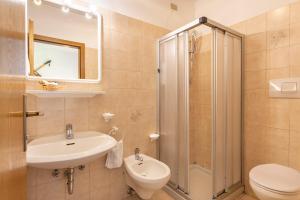 a bathroom with a sink toilet and a shower at Garnì Vajolet in Moena