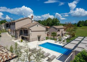 an aerial view of a house with a swimming pool at Villa Vesna with tennis court in Pićan