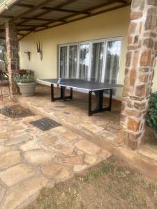 a ping pong table on a patio in a house at Khomas Hochland Chalet in Prospect