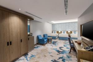 a hospital room with two beds and a television at View Al Madinah Hotel in Al Madinah