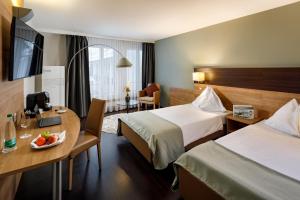 Katil atau katil-katil dalam bilik di Hotel Olten Swiss Quality