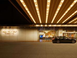 Nagoya Kanko Hotel في ناغويا: سيارة متوقفة أمام مبنى به أضواء
