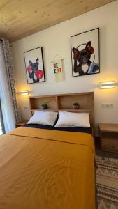 a bedroom with a bed and two pictures on the wall at Lovely one-bed with pool and beach access in Paje, Zanzibar! in Paje
