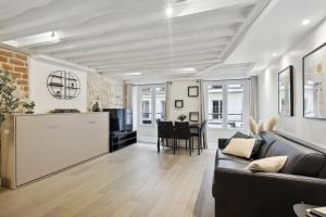 a living room with a couch and a table at mandar in Paris