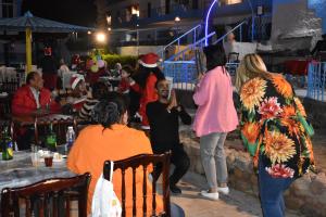 a group of people standing around at a christmas party at Regency Lodge Hotel in Sharm El Sheikh