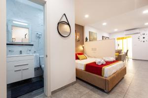 a bedroom with a bed and a bathroom at Modern & Lovely Studio - Prime location in St Julian's
