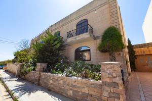 a brick building with a stone retaining wall at Modern & Lovely Studio - Prime location in St. Julianʼs