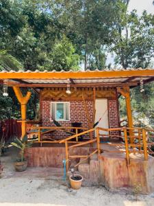 a house with a wooden structure with a patio at Full Moon Bungalow Resort Koh Chang Ranong in Koh Chang Ranong
