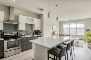 a kitchen with a white counter top and a kitchen island at Burlington 1br w gym wd nr dining shops BOS-978 in Burlington