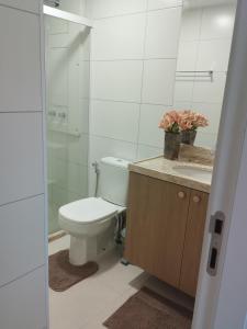 a bathroom with a toilet and a shower and a sink at Blue Beach pé na areia, Resort e praia in Cabedelo