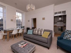 a living room with a couch and a table at Pass the Keys Bijoux Central Bath Period Apartment and Parking in Bath