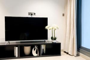 a flat screen tv sitting on top of a entertainment center at 1BHK Near Airport, Pool, Parking in Muscat
