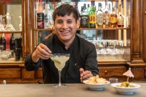 a man sitting at a bar with a drink at Adler Cavalieri Hotel-Private Spa & Gym in Florence