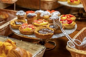 a platter of pastries on a display in a bakery at Adler Cavalieri Hotel-Private Spa & Gym in Florence