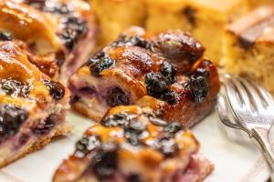 a plate of blueberry turnovers with a fork at Adler Cavalieri Hotel-Private Spa & Gym in Florence